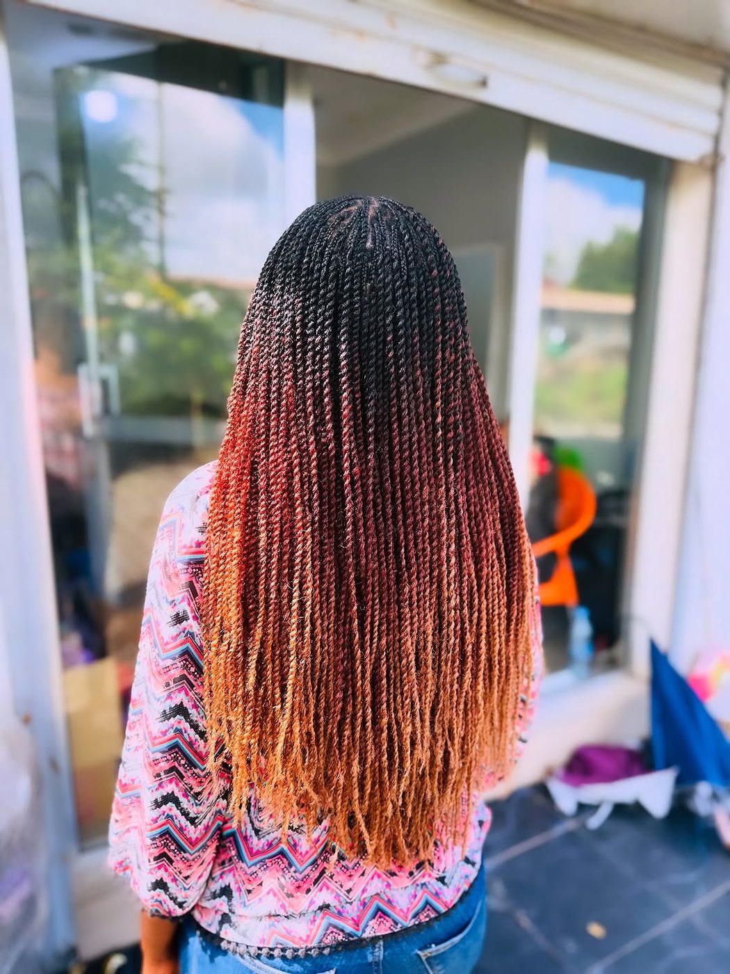 Long burgundy braids back view