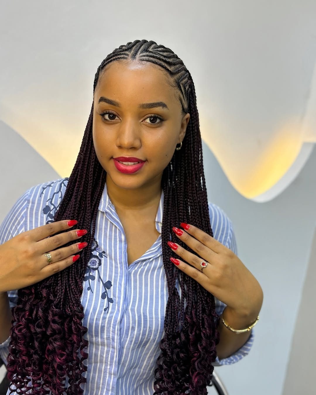 Cornrows with long burgundy braids styled at Perry Beauty